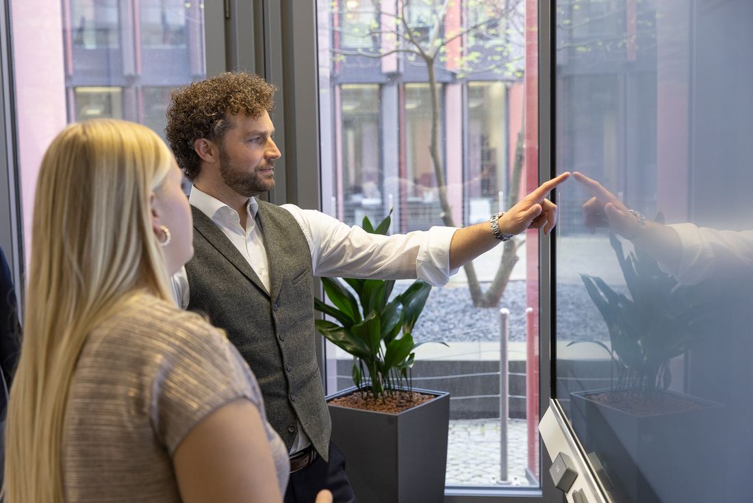 Colleagues collaborating by touch on a SMART Board